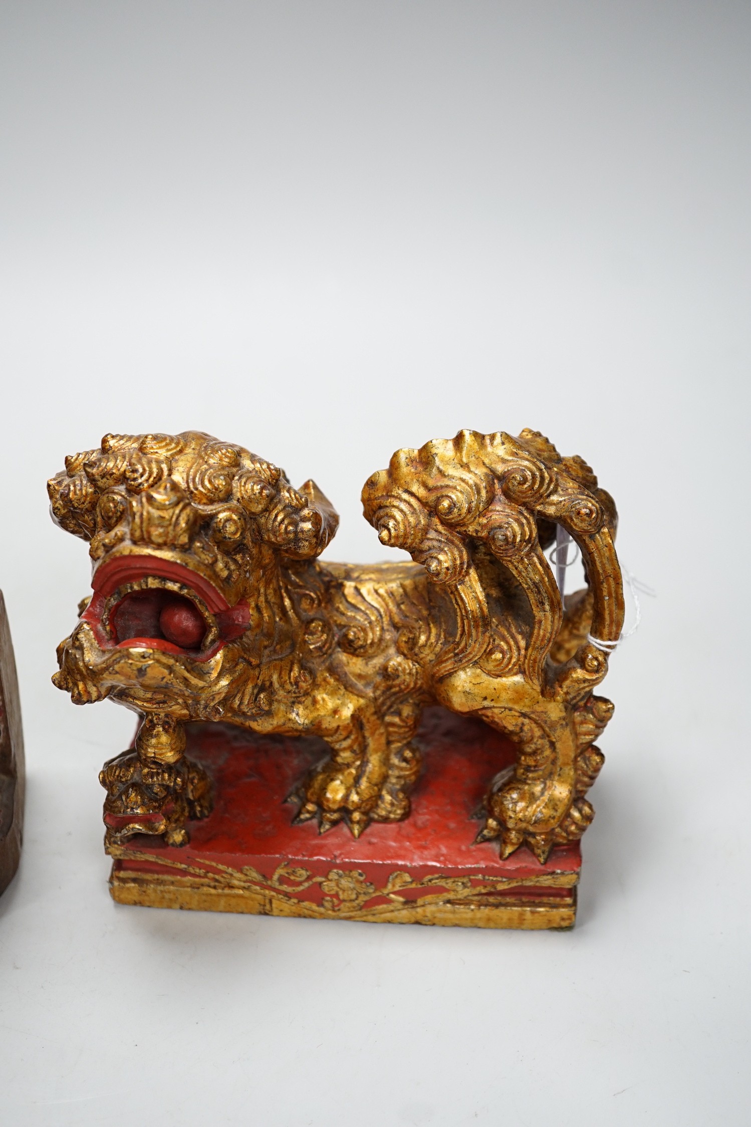 A Chinese lacquered wood figure of a seated woman and a Buddhist lion, tallest 20.5cm